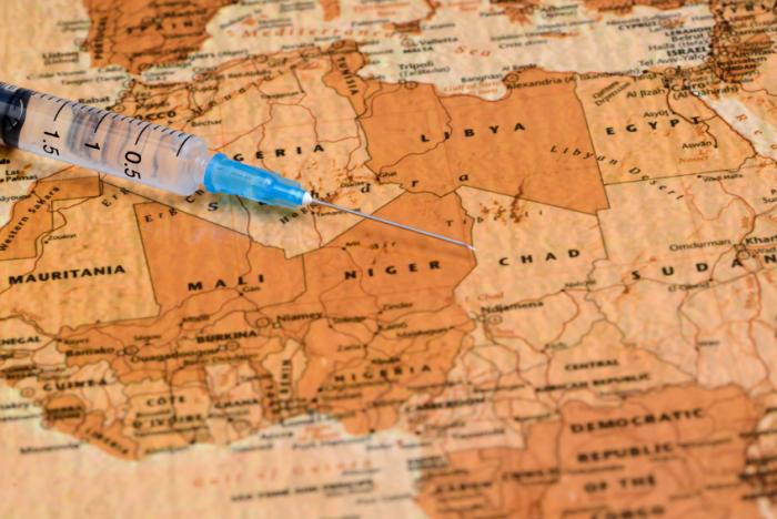 A syringe on an African map